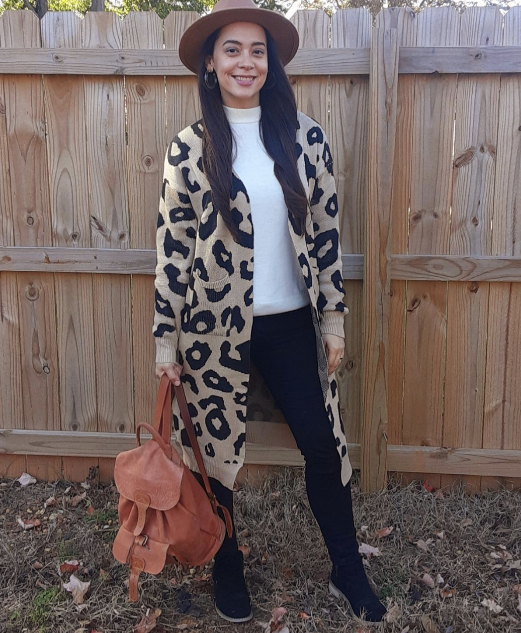 reviewer wearing the leopard print long open front cardigan with pockets