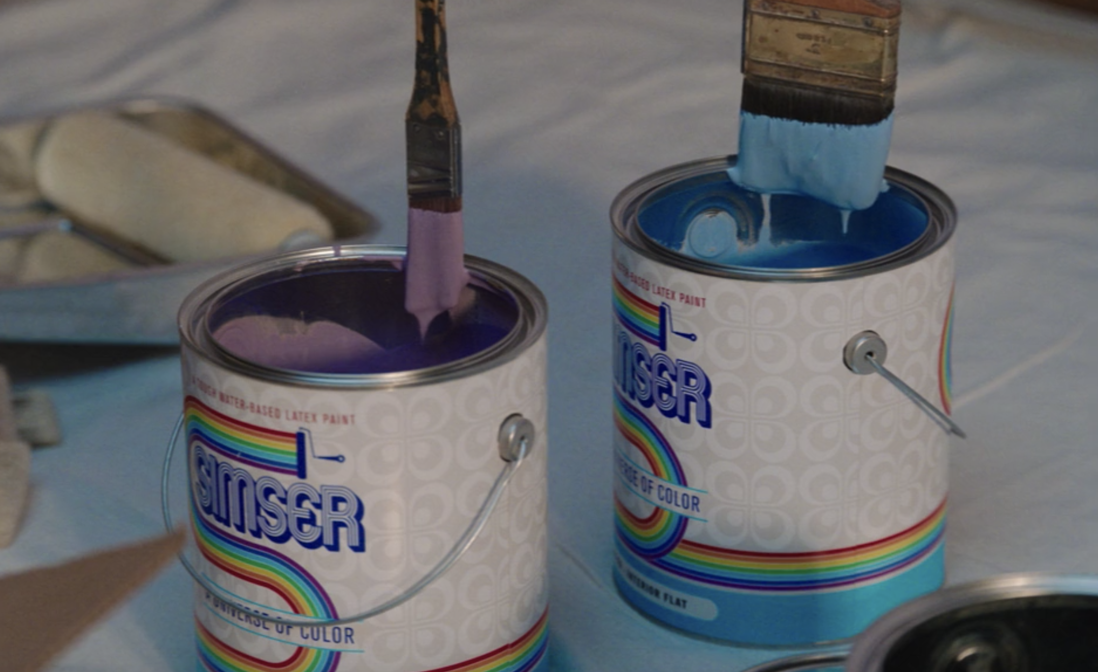 Purple and blue paint cans that say, &quot;Simser&quot;