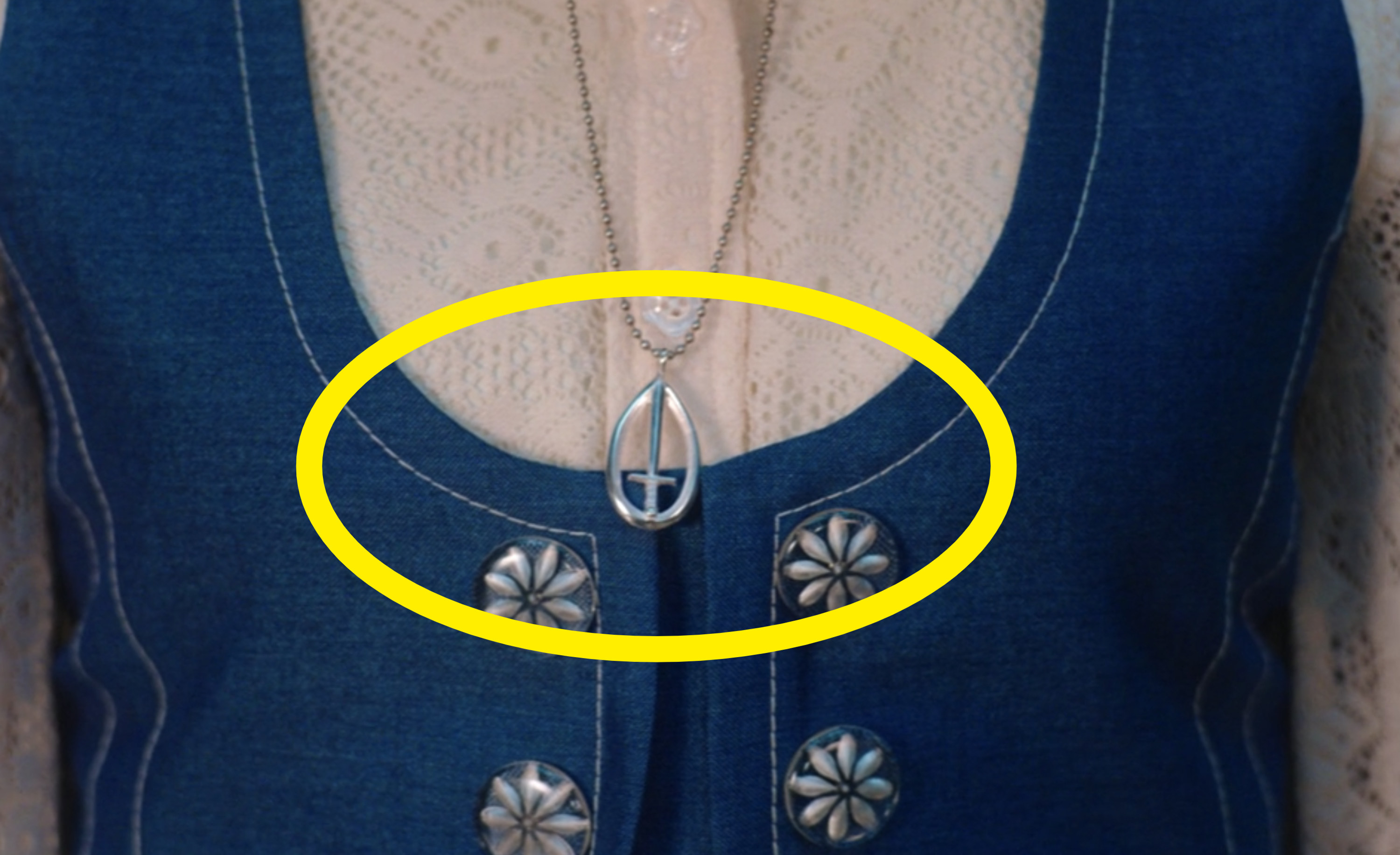 Geraldine&#x27;s silver necklace that features a S.W.O.R.D. logo pendant 