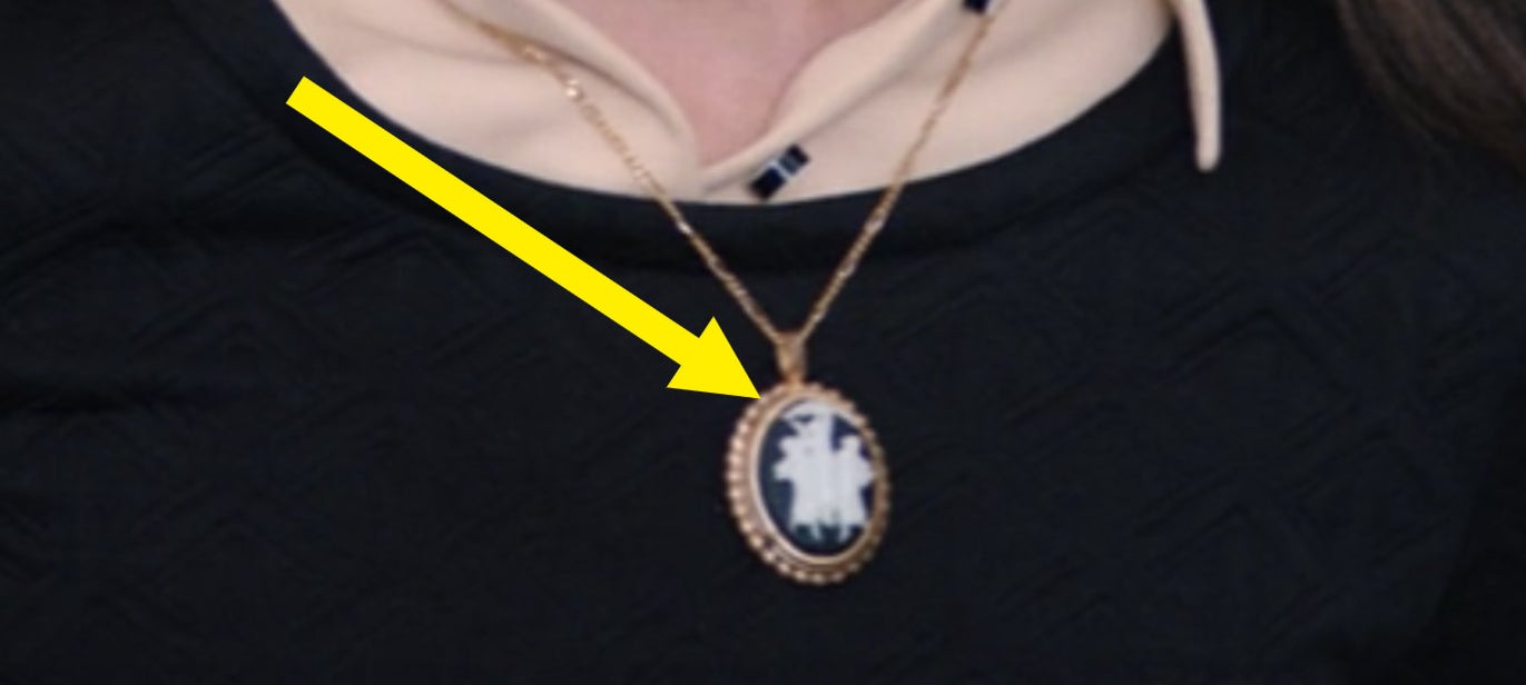 A close-up of Agnes&#x27;s broach/necklace