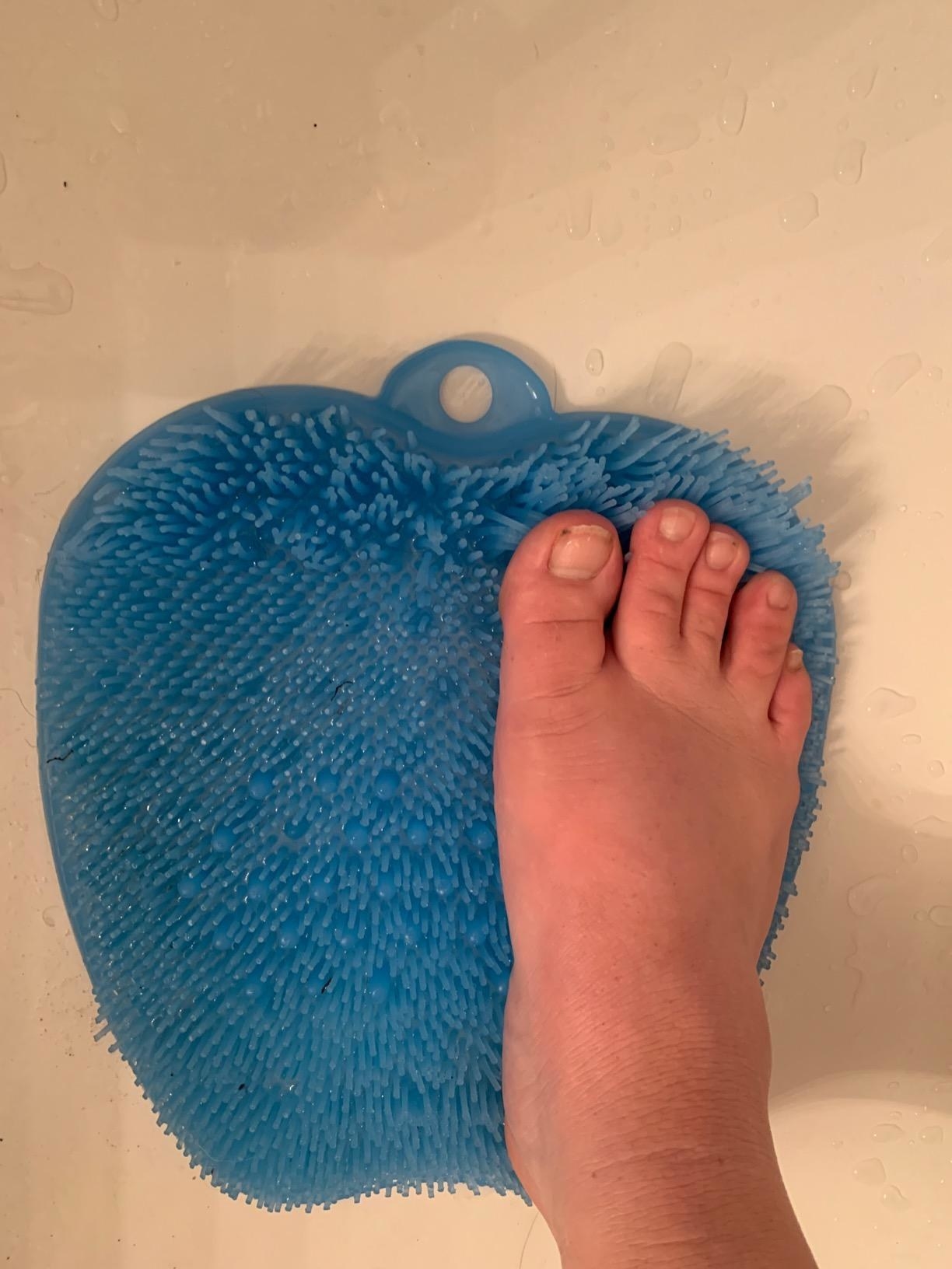 Reviewer using the foot massager and scrubber