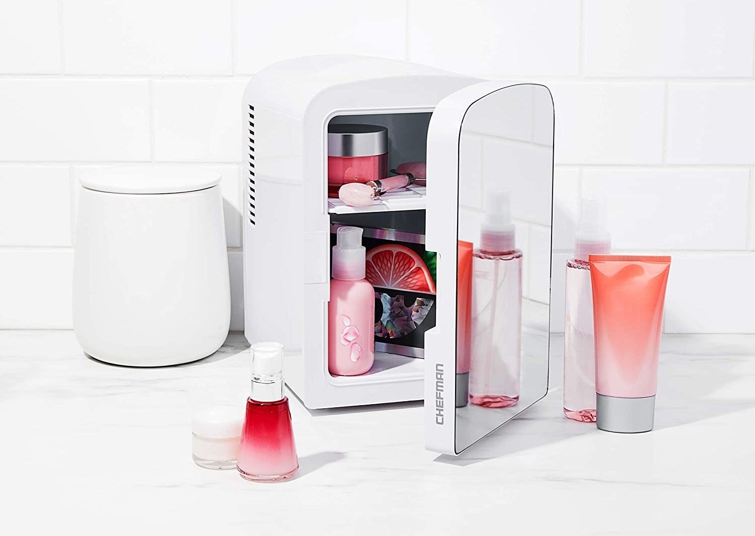 The mirrored four-liter mini fridge which has two shelves