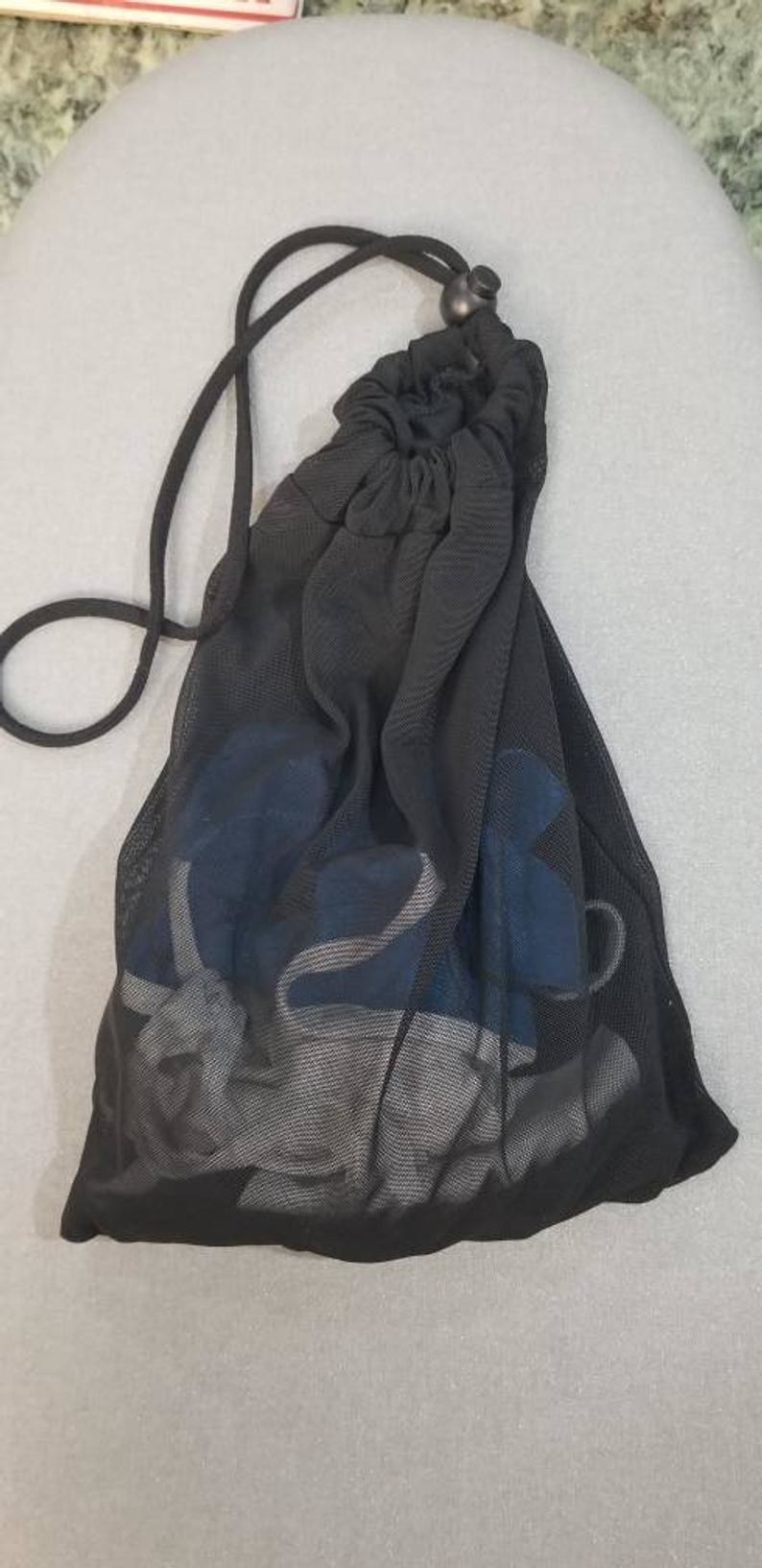 the mesh black bag with cloth face masks in it 