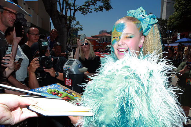 JoJo Siwa signing autographs at a press event