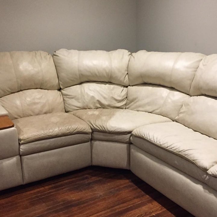 reviewer photo showing their white sectional half dirty, half cleaning restored after using the leather honey 
