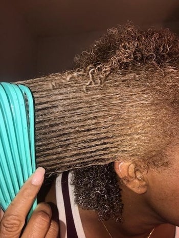 same reviewer easily brushing through their hair with the detangling brush