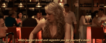 A woman in her bar reaching and grabbing a jar of Vegemite; the text reads &quot;When you got bread and Vegemite, you got yourself a meal&quot;