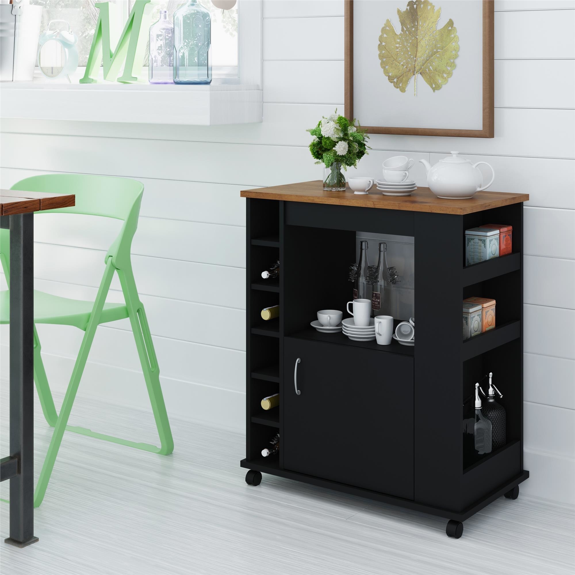 a black kitchen cart on wheels with shelves, wine holders, and a drawer