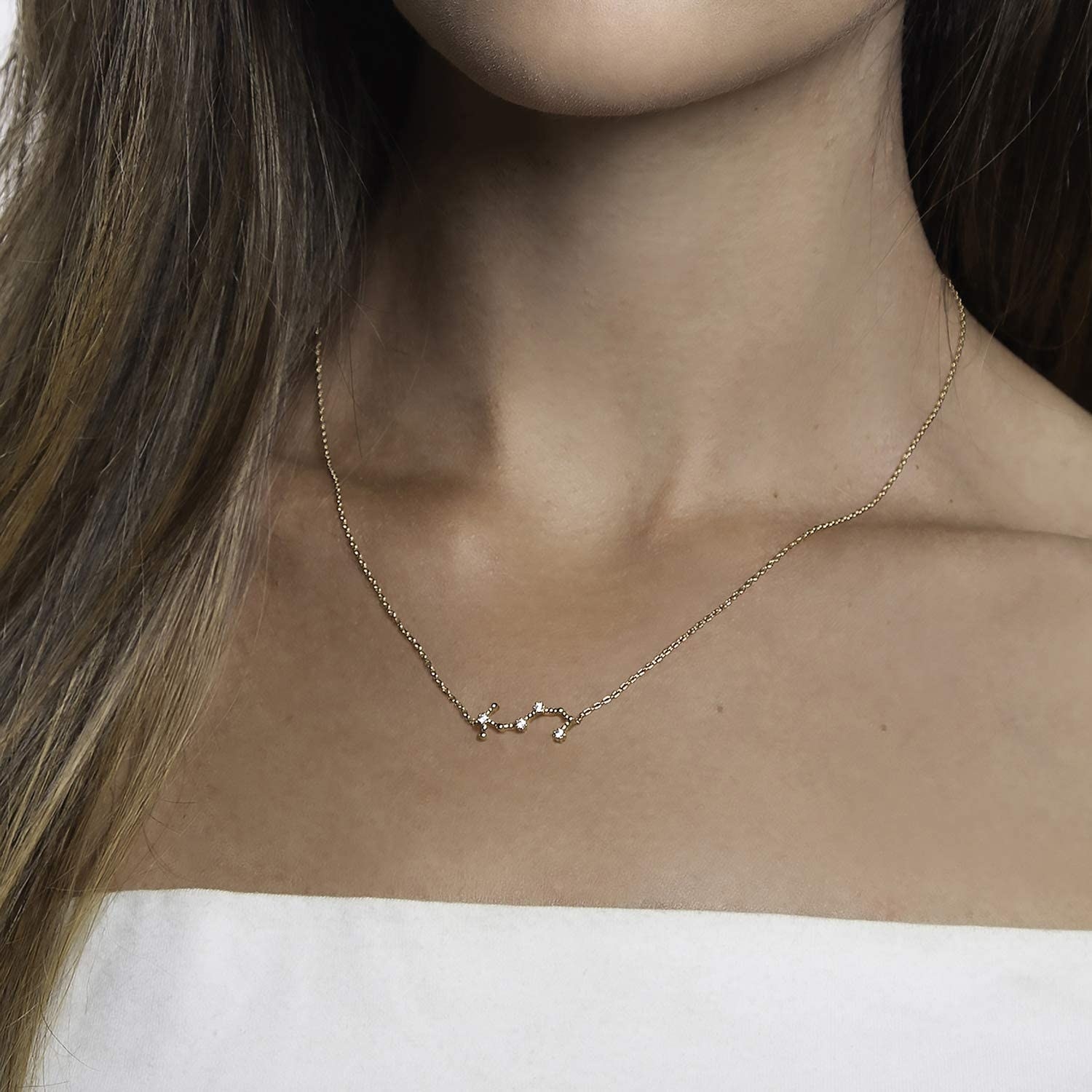 Model wearing the gold and rhinestone necklace in the shape of the Scorpio constellation
