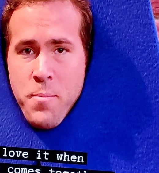 A closeup of Ryan&#x27;s face in the opening of the letter &quot;A&quot; costume