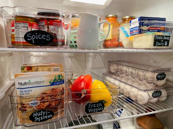 A reviewer's photo of their fridge organized with the six clear containers