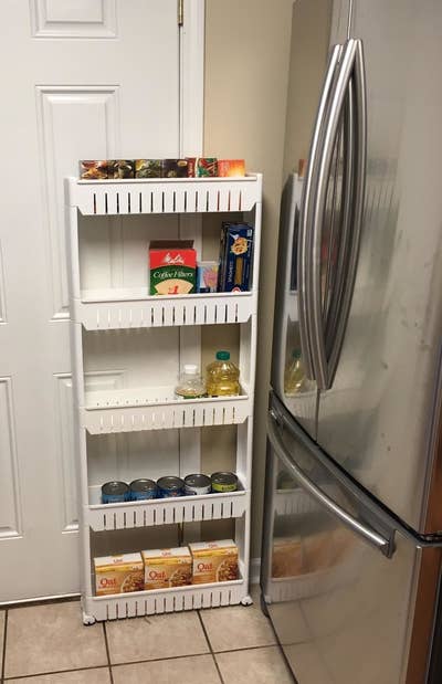 The same reviewer's photo of the five-tier rack pulled out from the wall