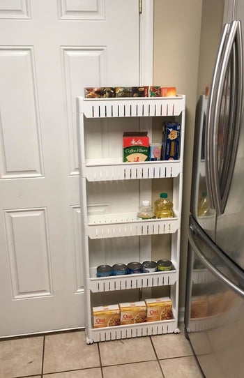 The same reviewer's photo of the five-tier rack pulled out from the wall