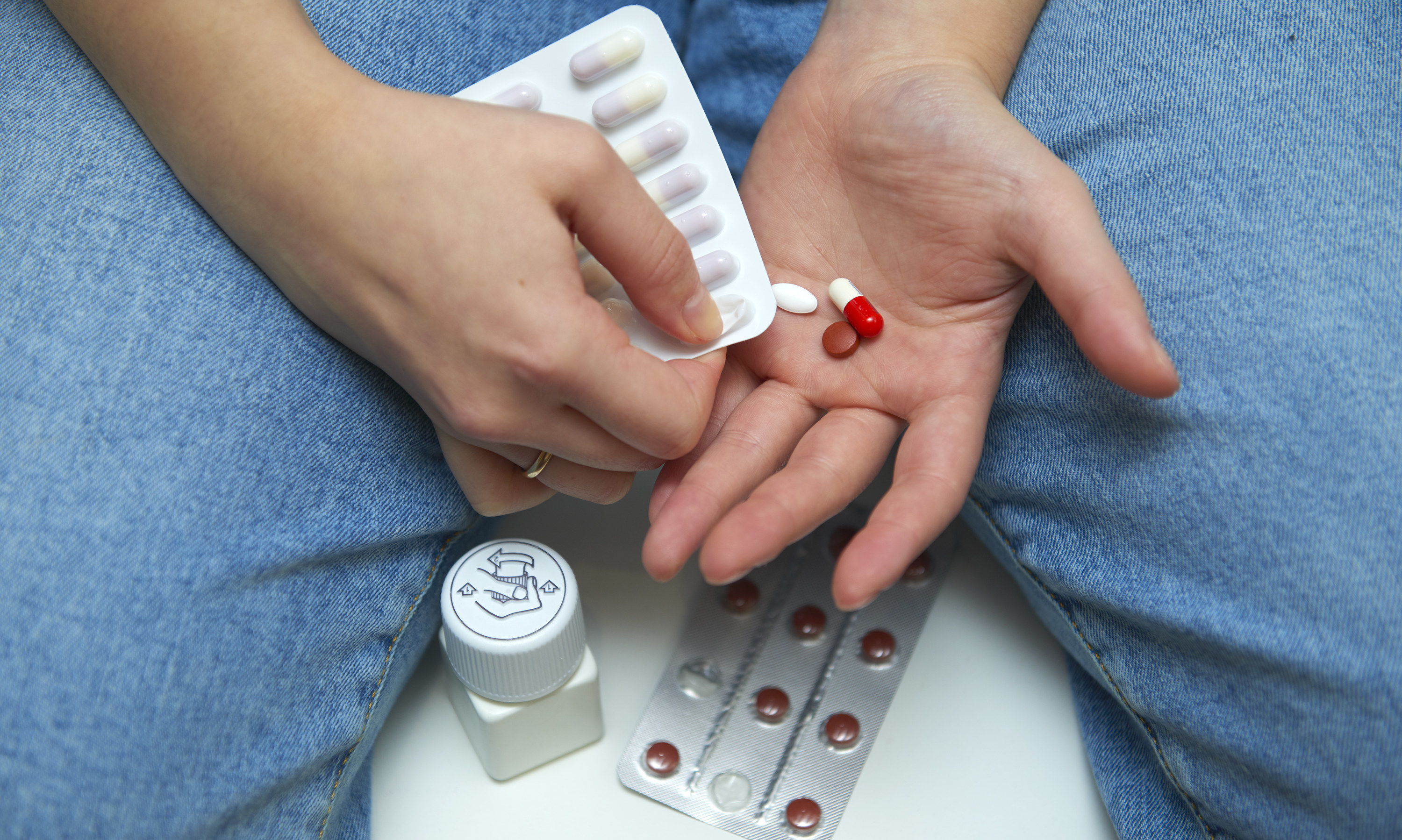 Patient popping pills out of a blister pack