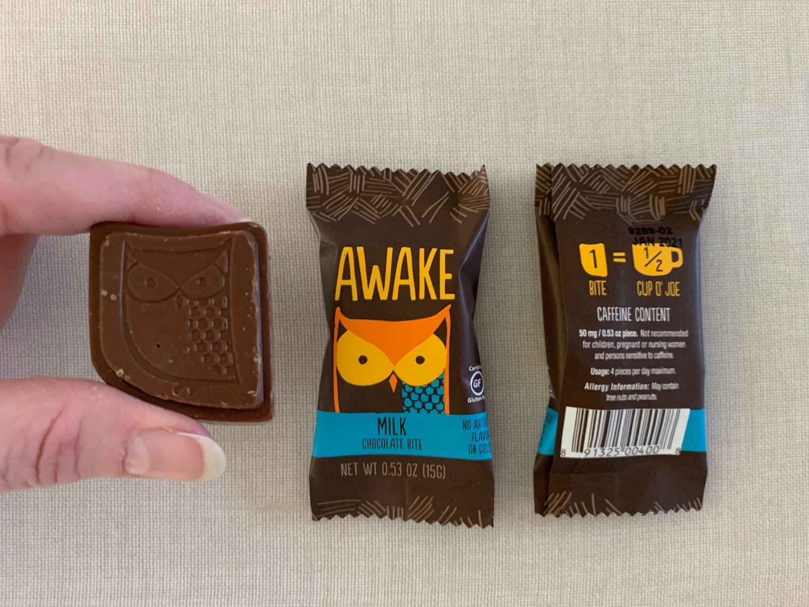reviewer image of a customer&#x27;s hand holding an unwrapped awake milk chocolate bit