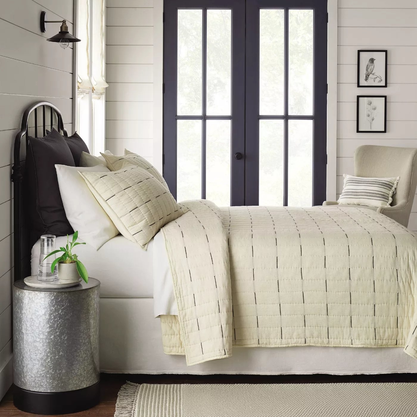 The beige quilt with gray stripes