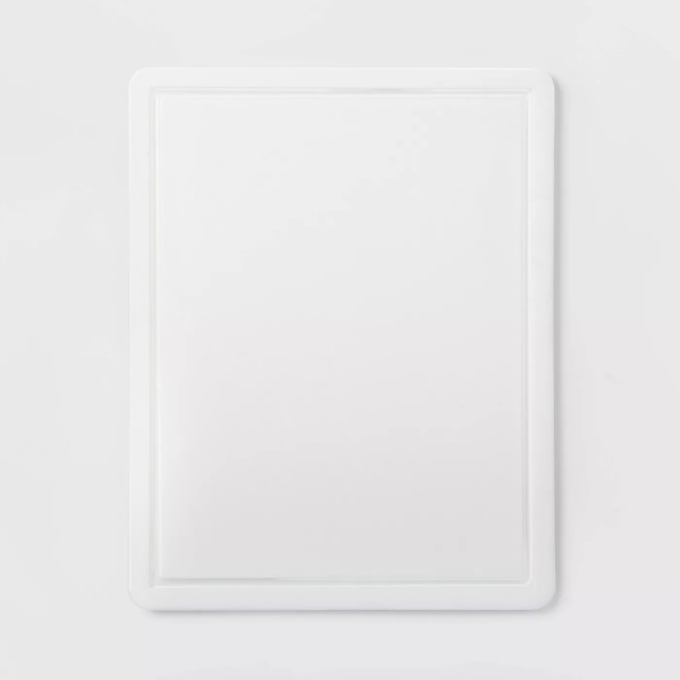 The white, grooved, nonslip cutting board