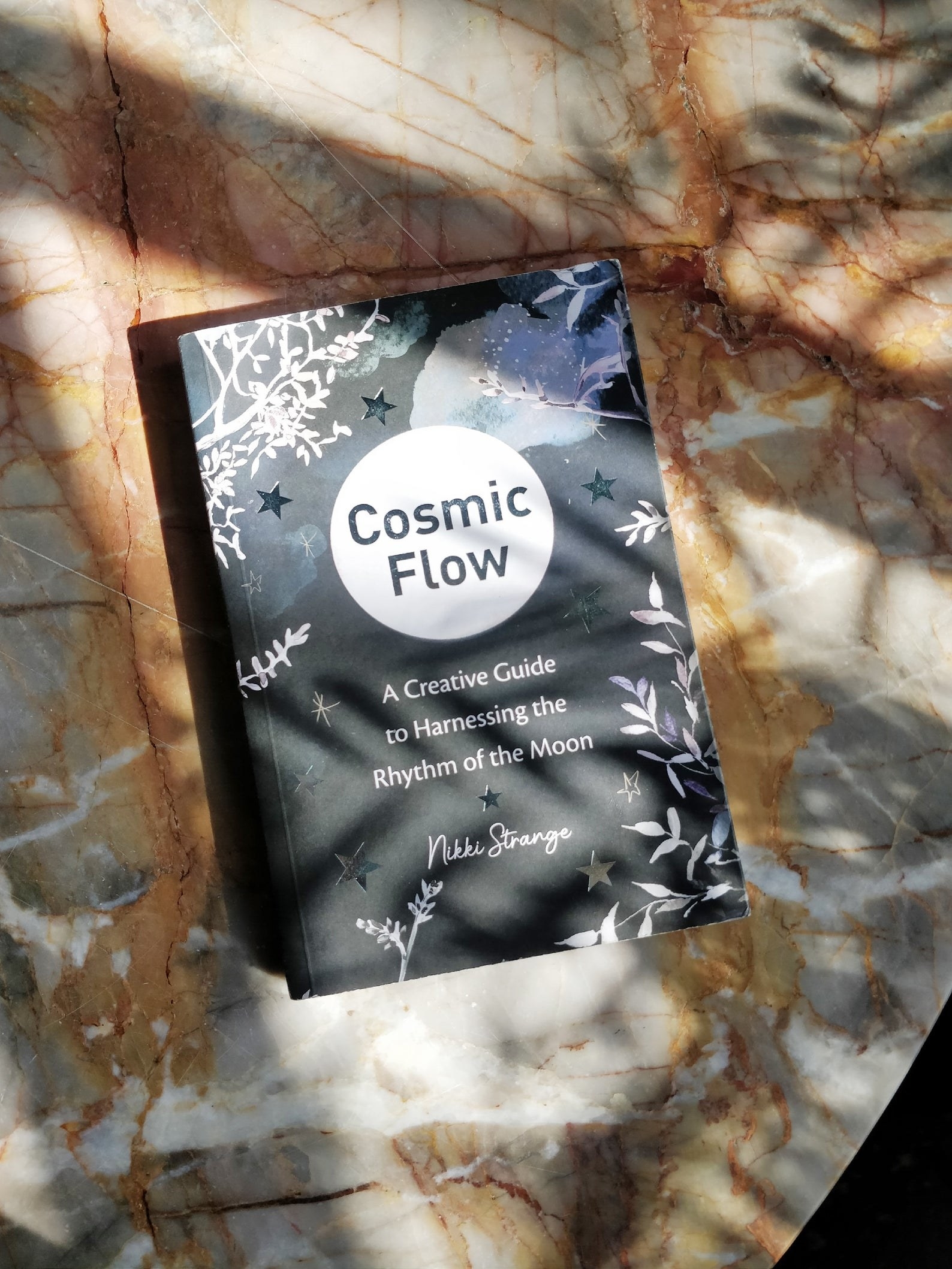 a copy of Cosmic Flow on a marble counter