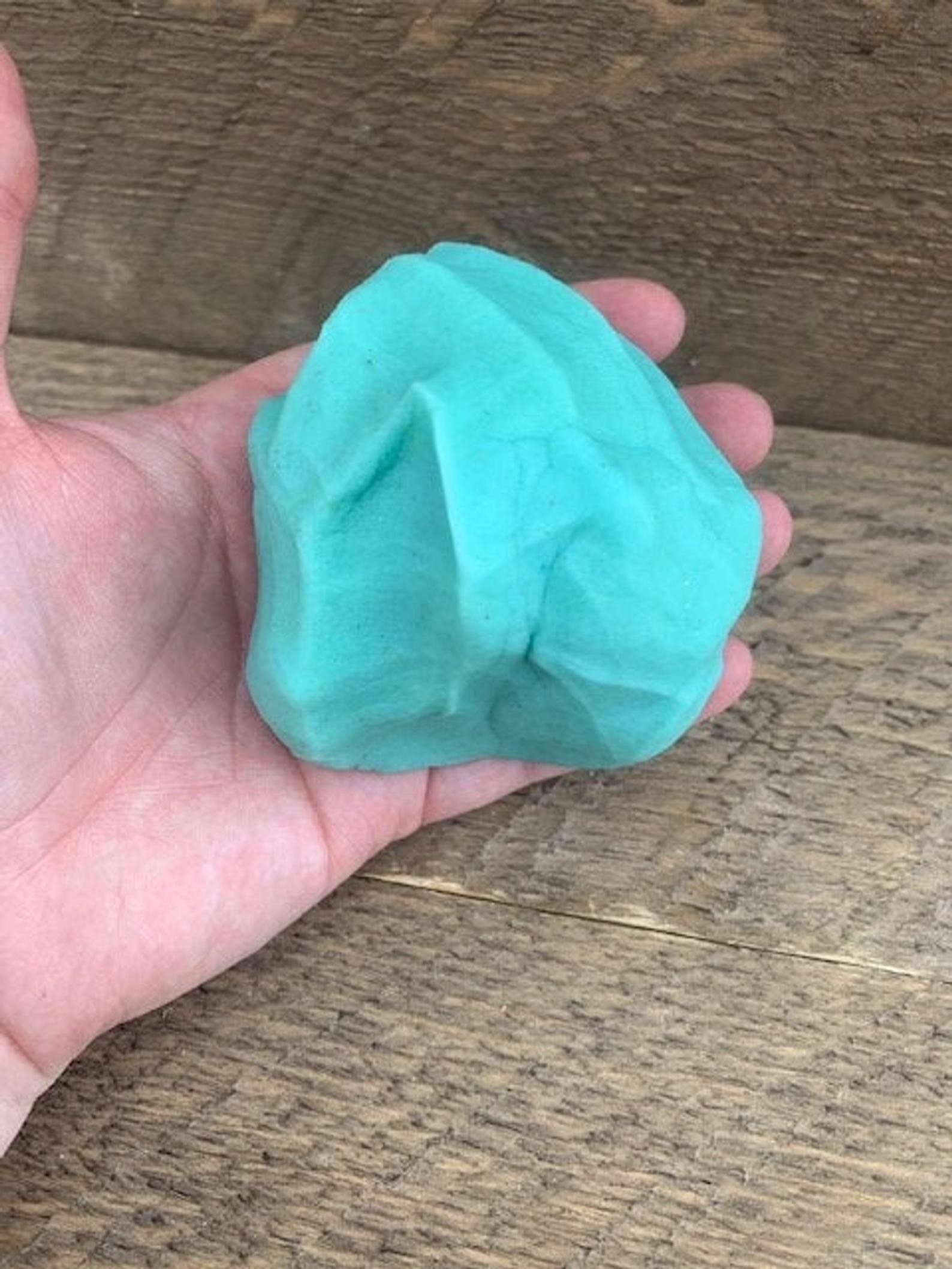 person&#x27;s hand with ball of dough