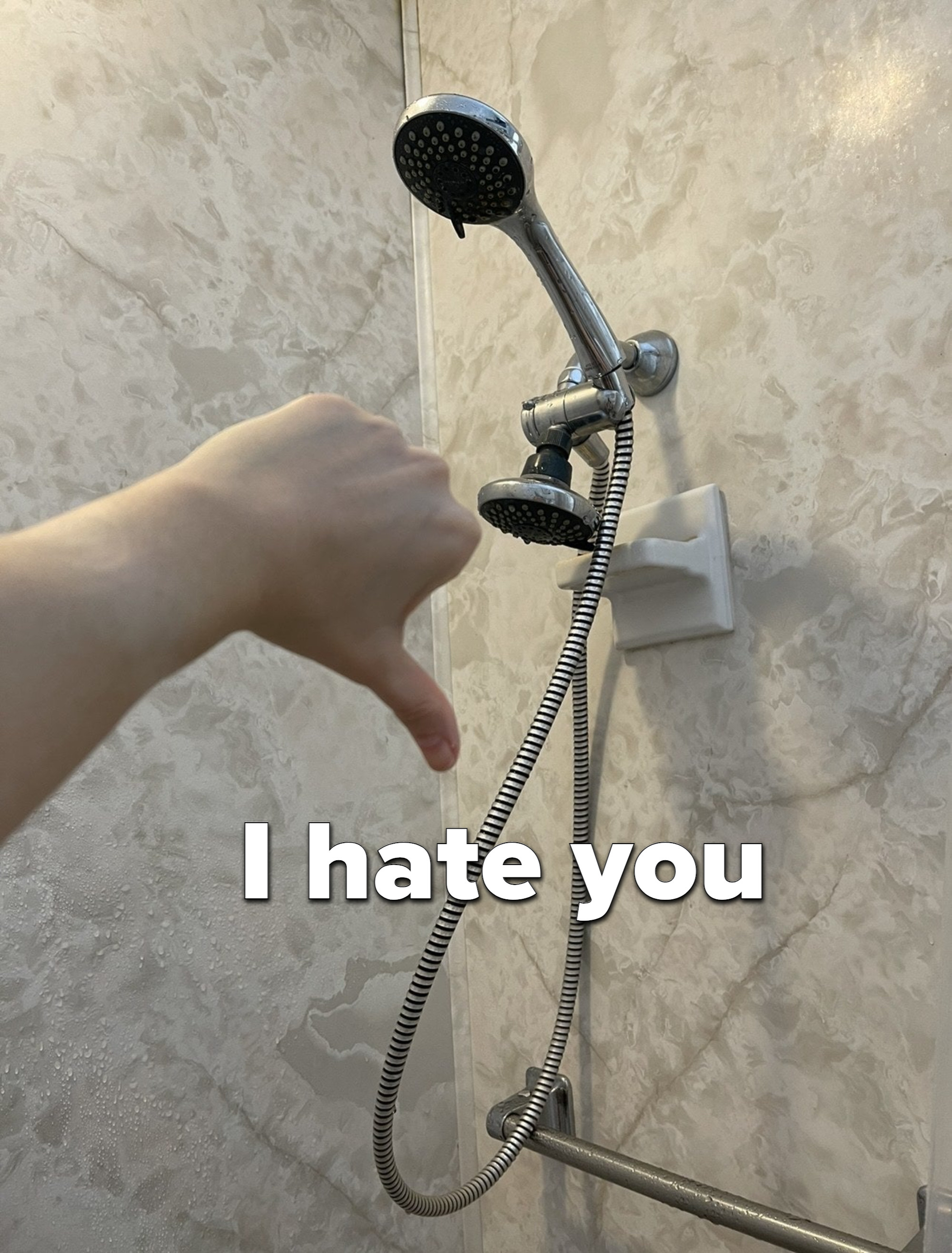 A showerhead and a thumbs-down