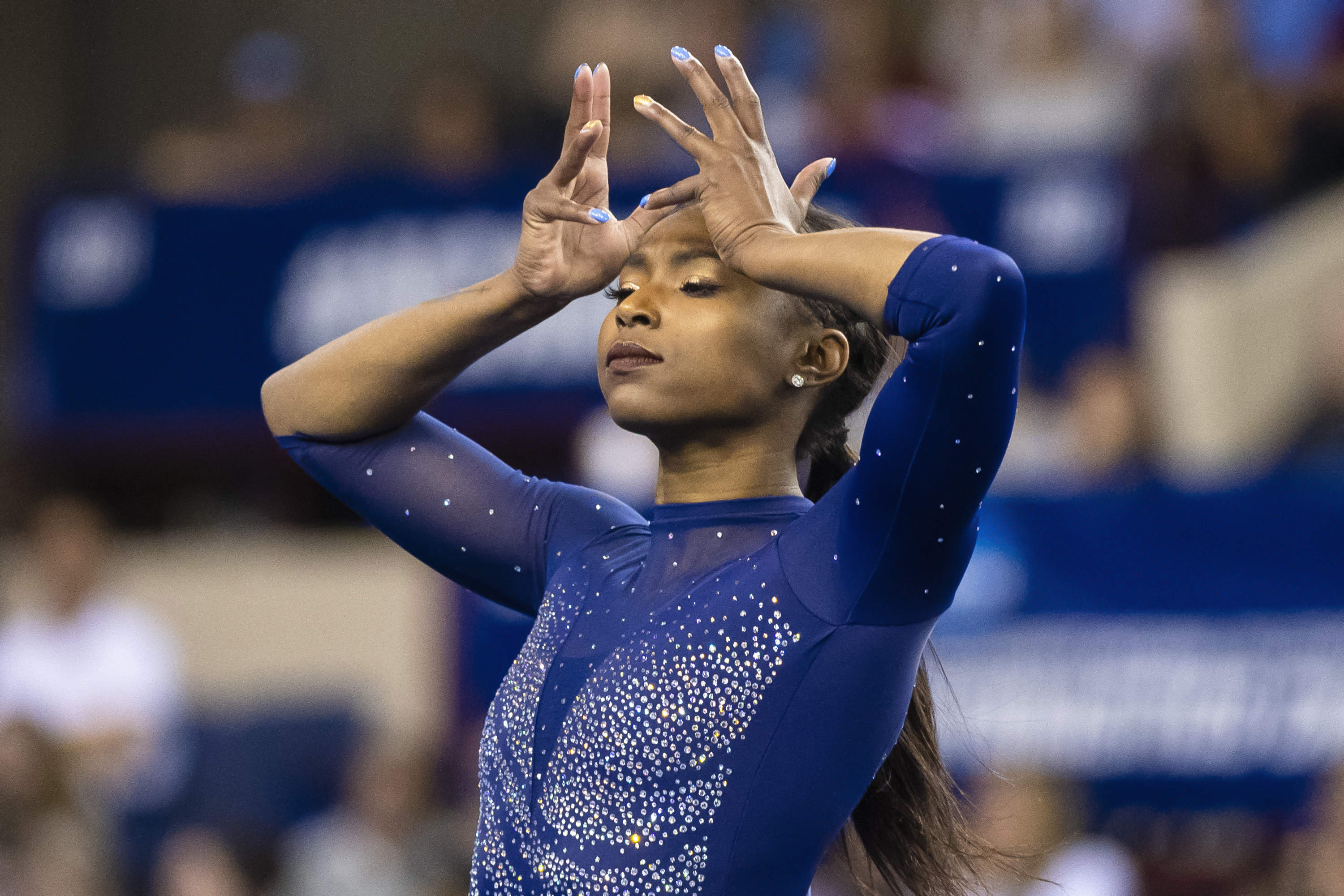 Gymnast Nia Dennis poses during her floor routine