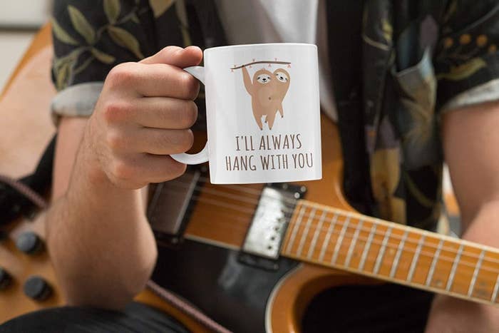 person holding a mug with sloth drawings that says I&#x27;ll always hang with you