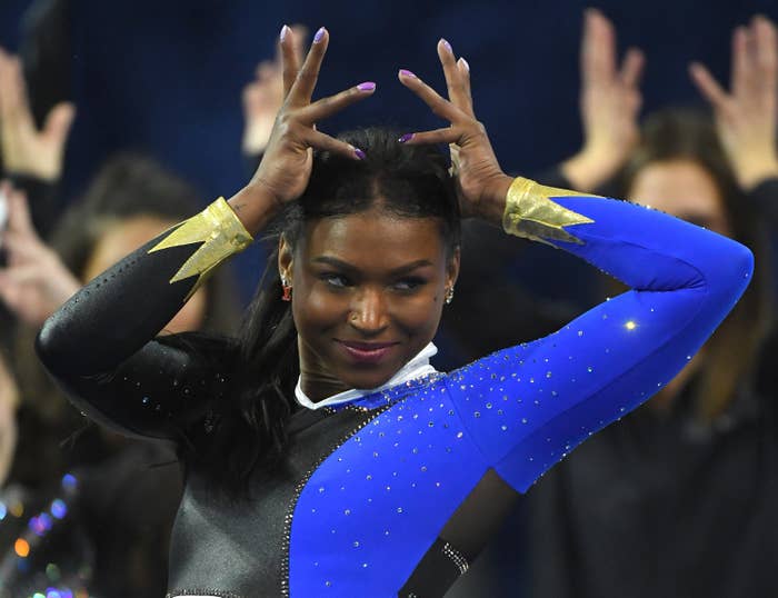 Gymnast Nia Dennis poses during her routine