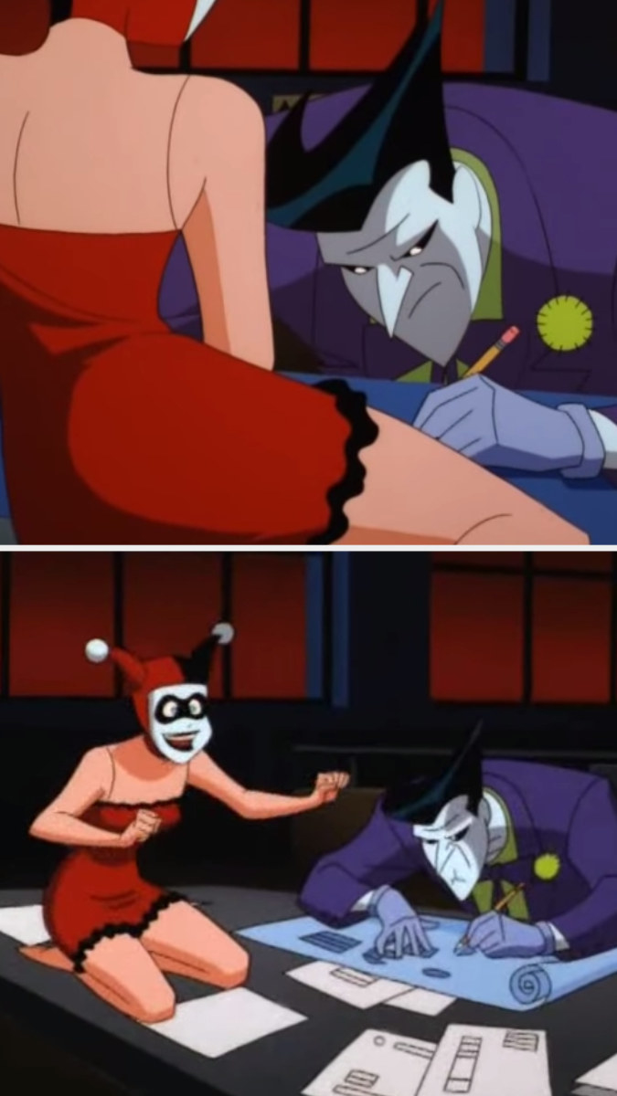 Harley Quinn kneels on the Joker&#x27;s desk as if she were riding a motorcycle while wearing a red night and her harlequin headpiece 