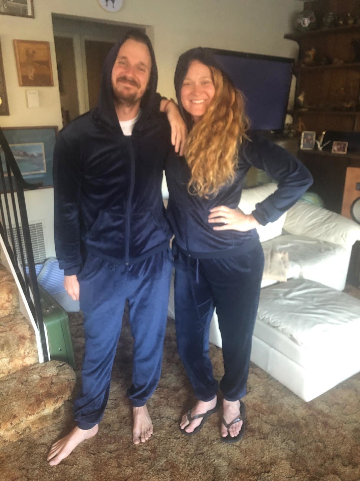 Two reviewers wearing matching blue tracksuits