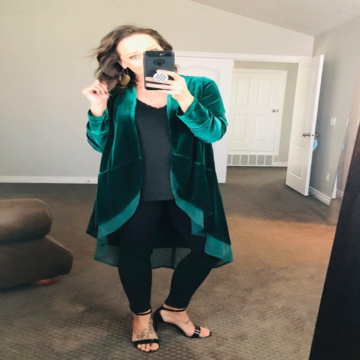A reviewer wearing the green duster with sheer ruffled trim
