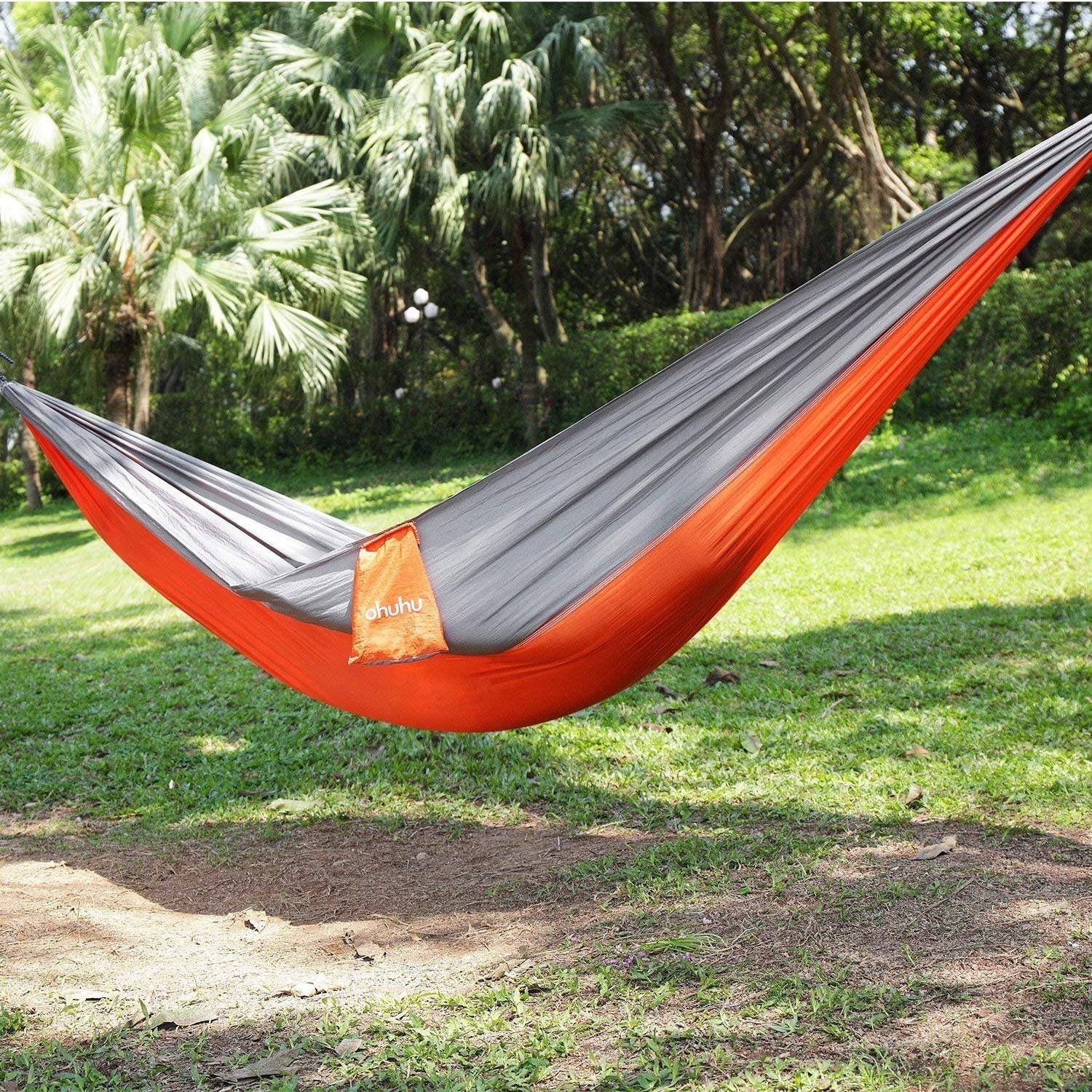 person lying in the hammock that&#x27;s attached to trees