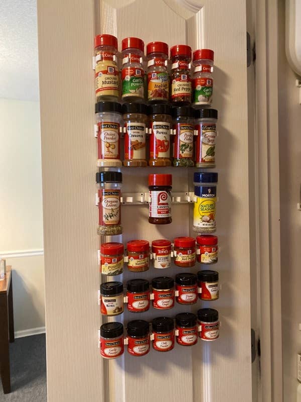 A reviewer's photo of the white rack used on the inside of a closet door