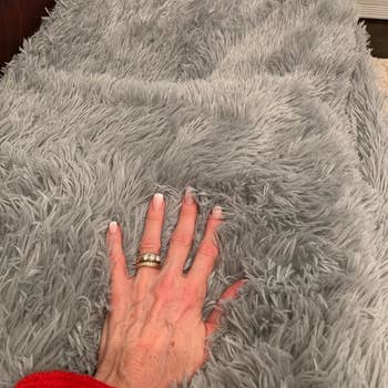 Reviewer's hand showing the softness of the blanket