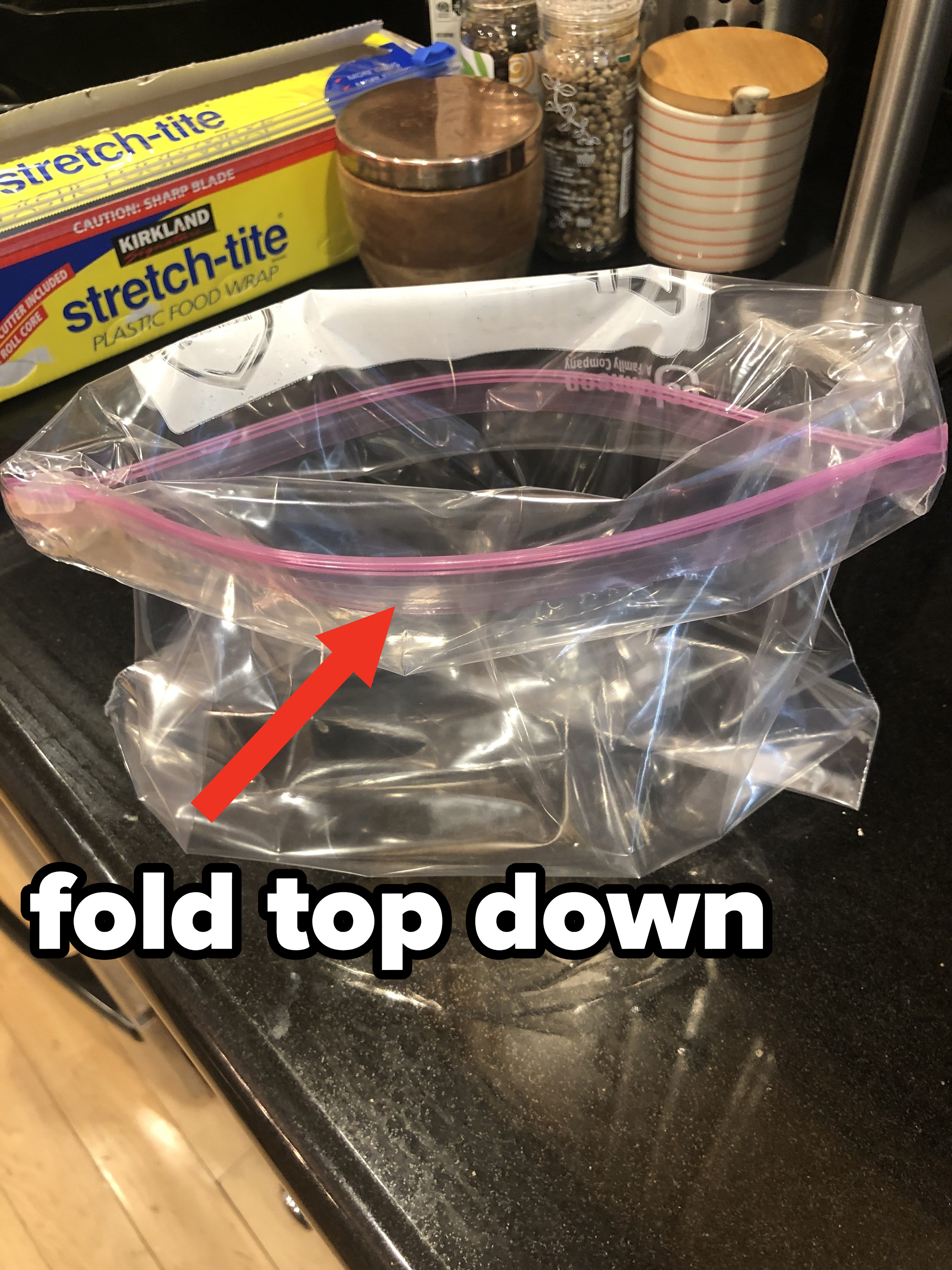 A Ziploc bag sitting on a kitchen countertop — with the very top of the bag folded down onto itself