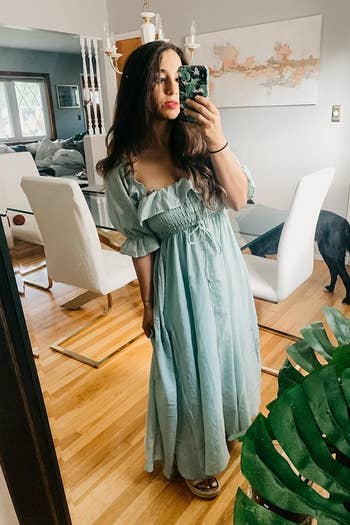 A reviewer wearing the ruffled short-sleeve dress in mint green
