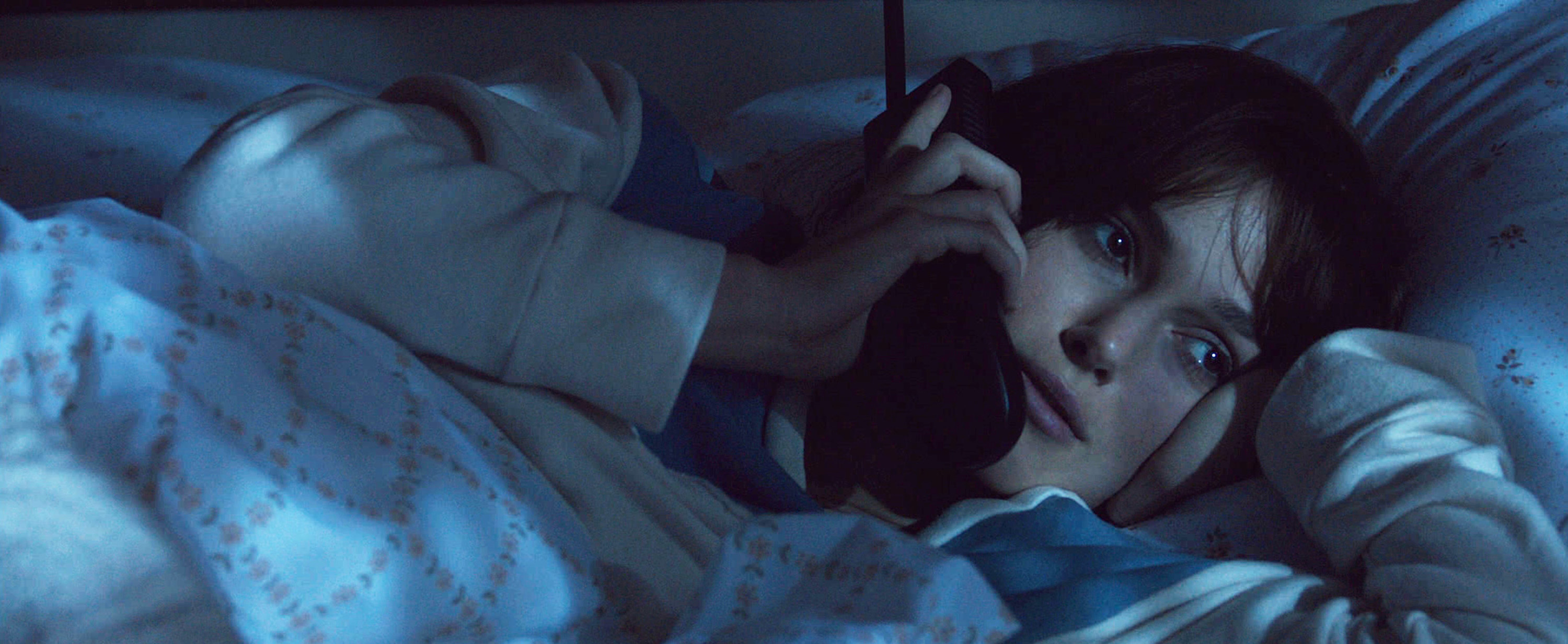 Keira Knightley talks on the phone in bed in the 2015 film Everest