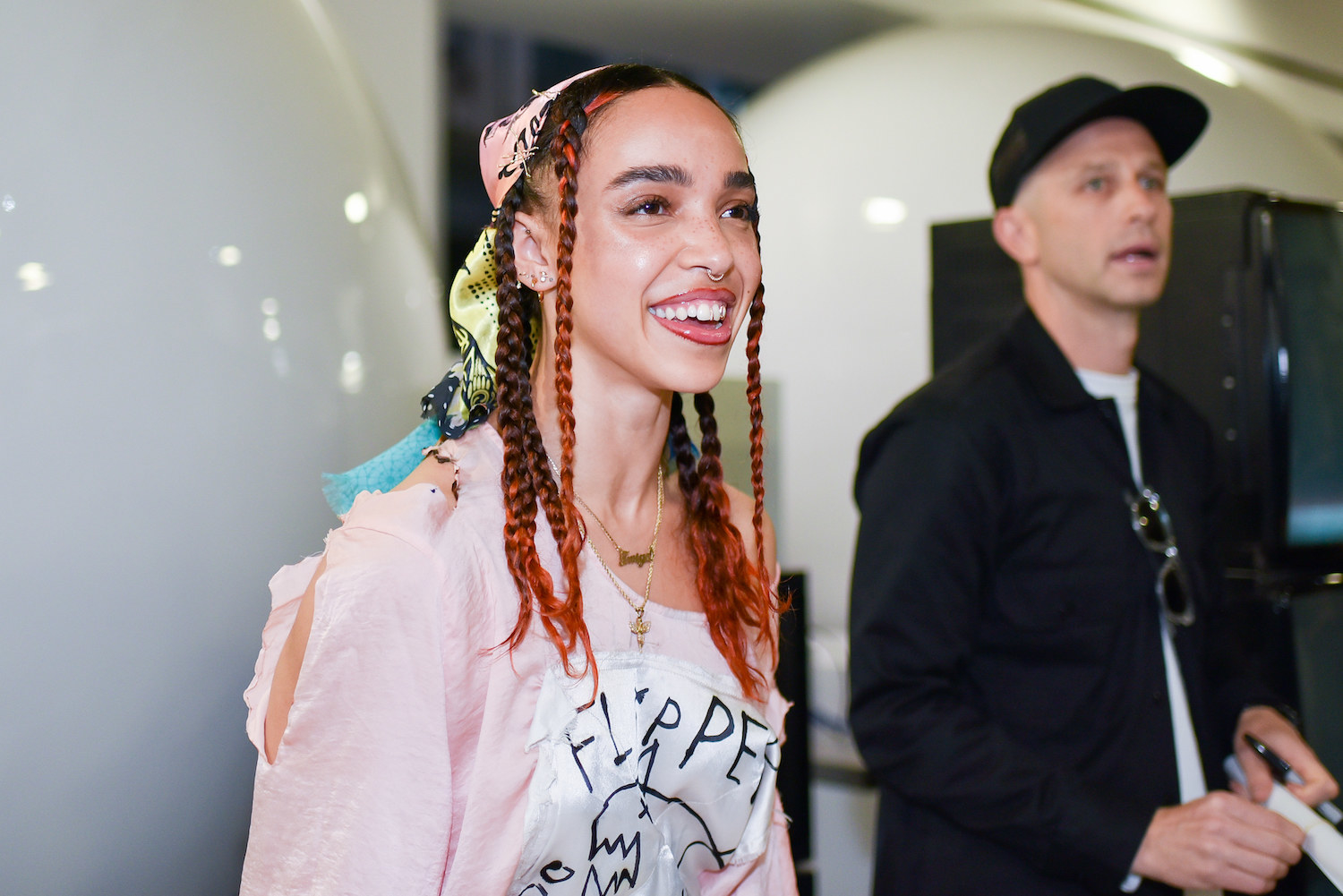 British singer and songwriter FKA Twigs smiles at an event at Dover Street Market during London Fashion Week 