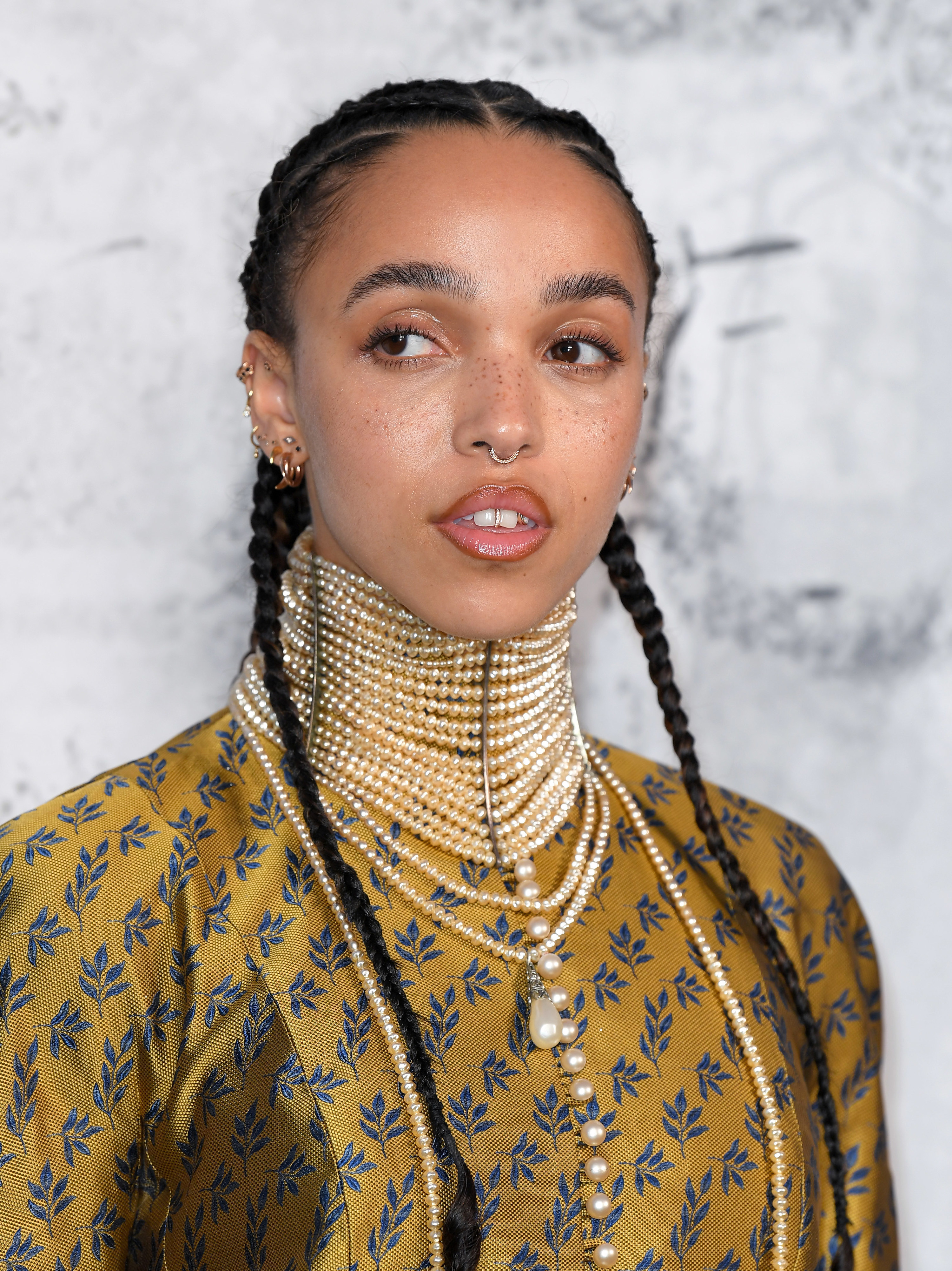 FKA Twigs attends The Summer Party 2019 Presented By Serpentine Galleries And Chanel wearing a high-collared pearl necklace and her hair braided back