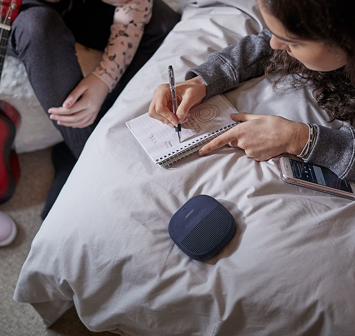A person lying next to the speaker in bed