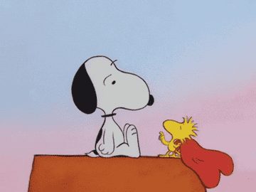 Woodstock the bird from Peanuts playfully throwing a heart at Snoopy&#x27;s face 