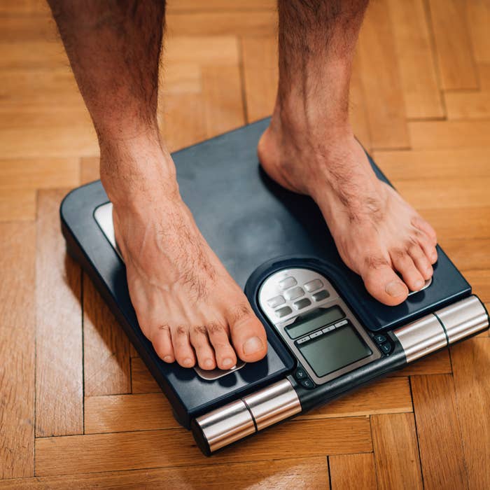 Man weighing himself on the scale