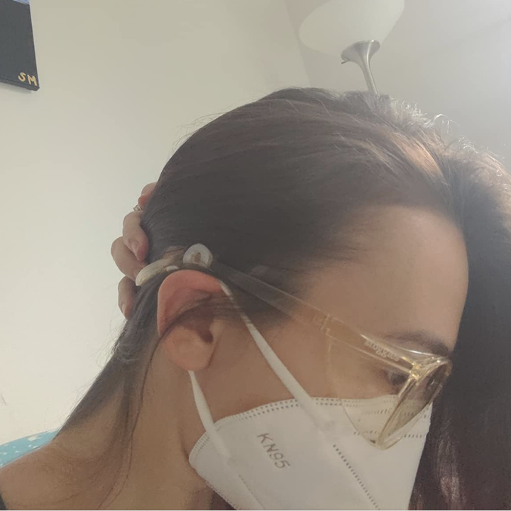 Reviewer showing the silicone guard installed on their glasses temple 