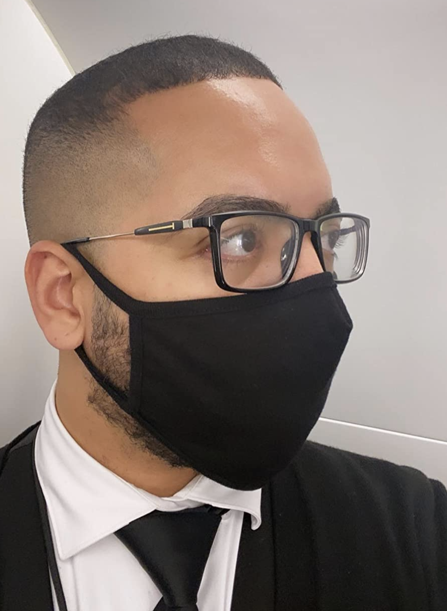 Reviewer image wearing a black face mask with around the ear loops and glasses that are not fogged 