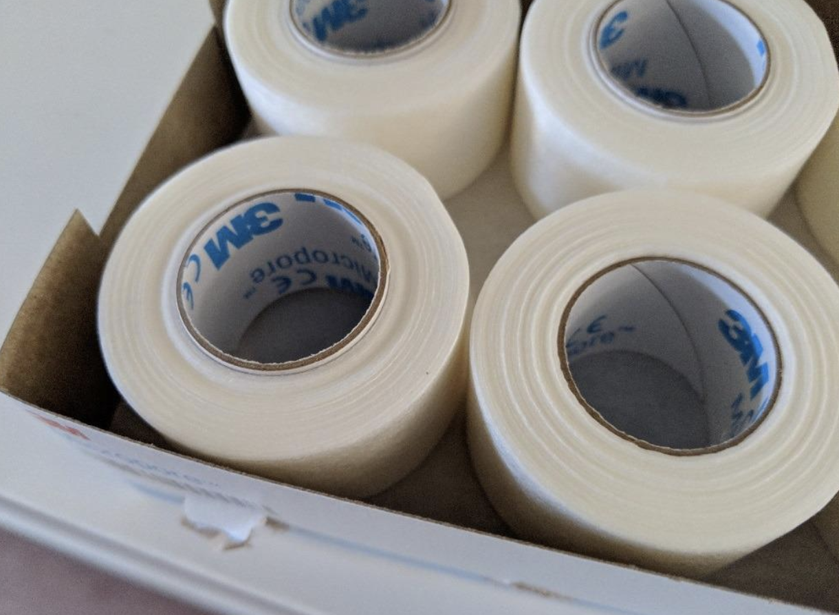 Rolls of white micropore tape in a box 