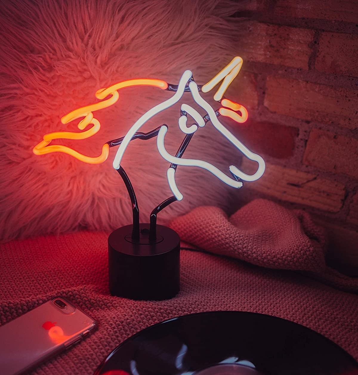 The unicorn light on a bed