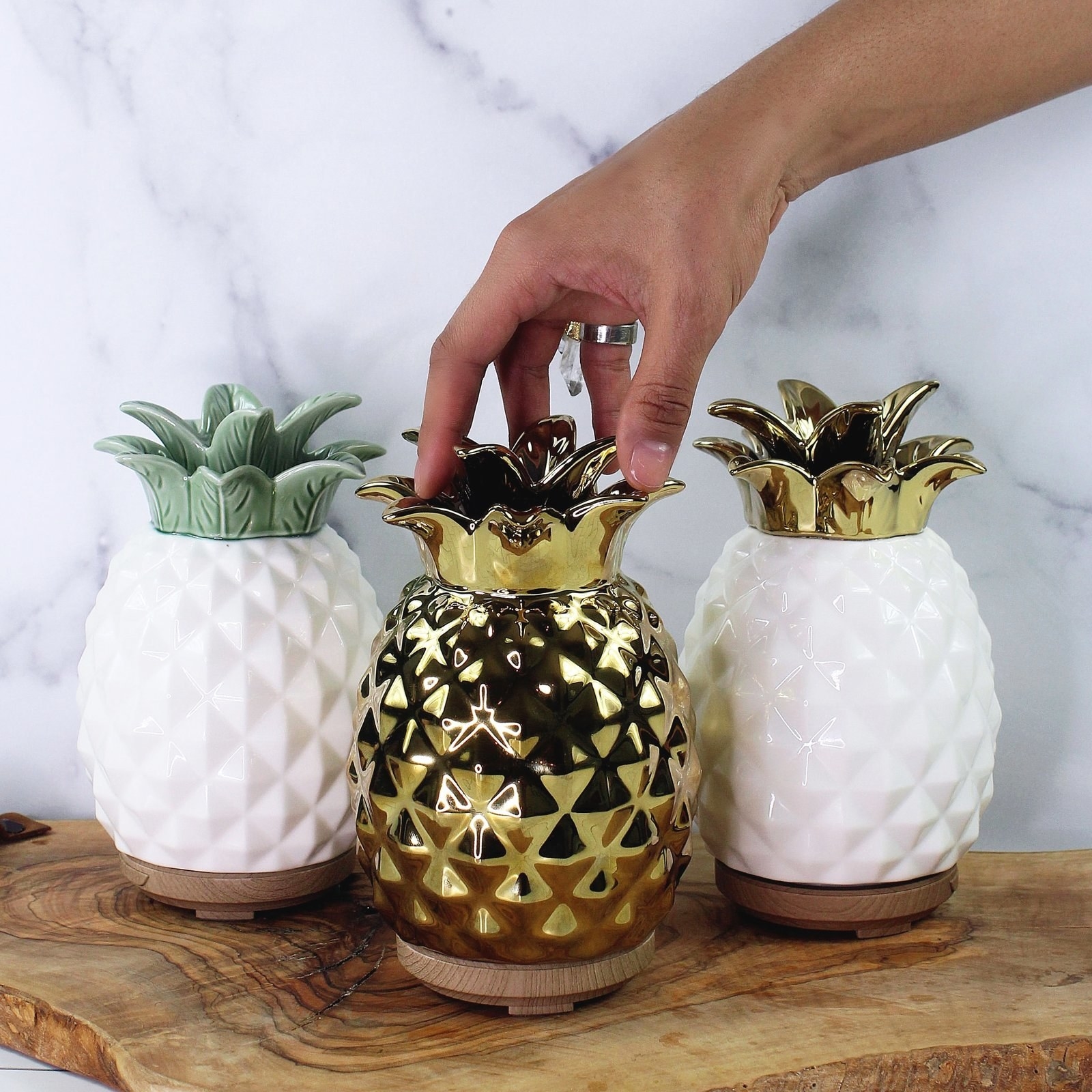 Three pineapple-shaped diffusers in different color options