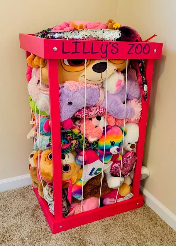 A pink stuffed animal zoo customized with "Lilly's zoo"