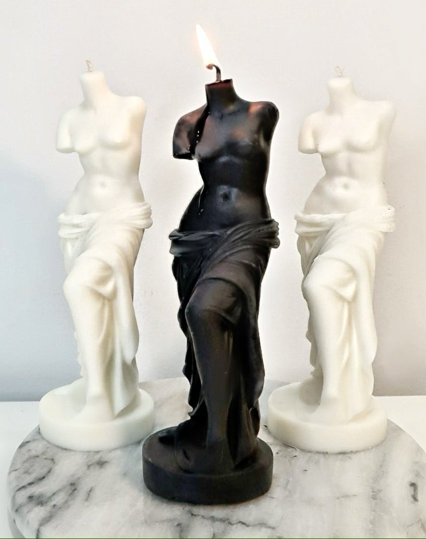 three candles in black and white