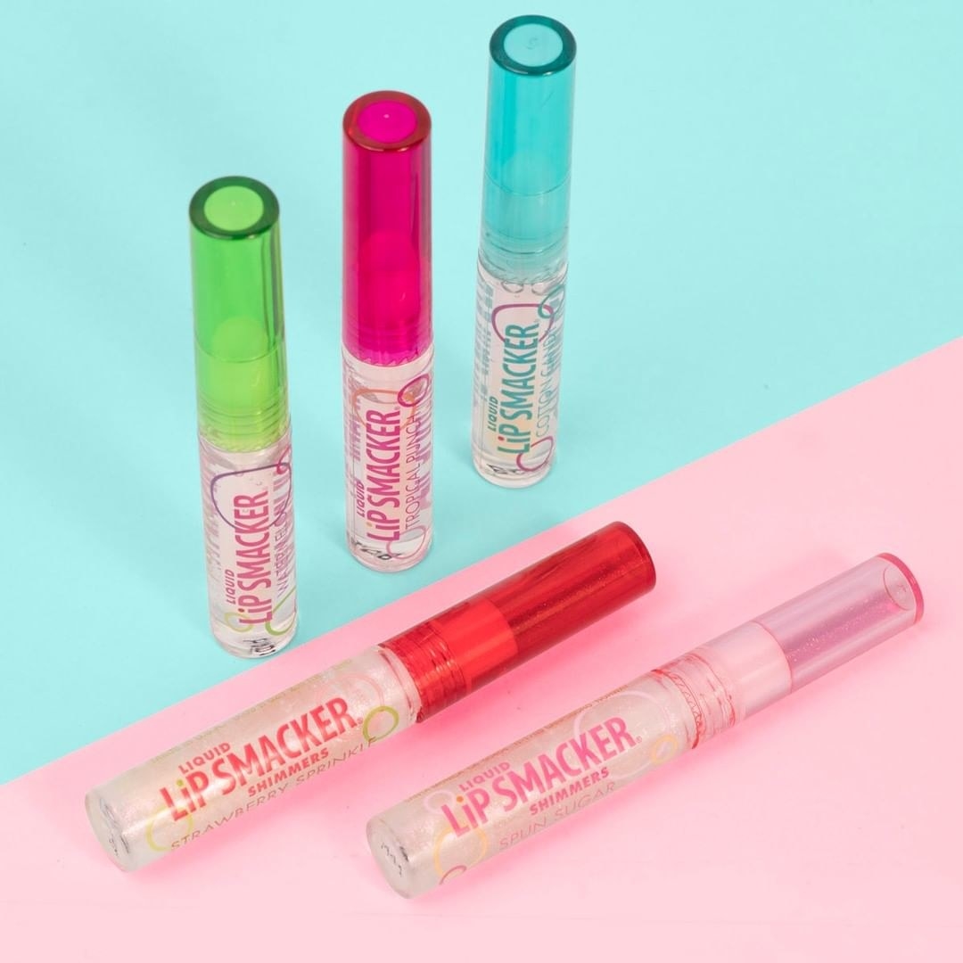 Five tubes of lip gloss in a pile