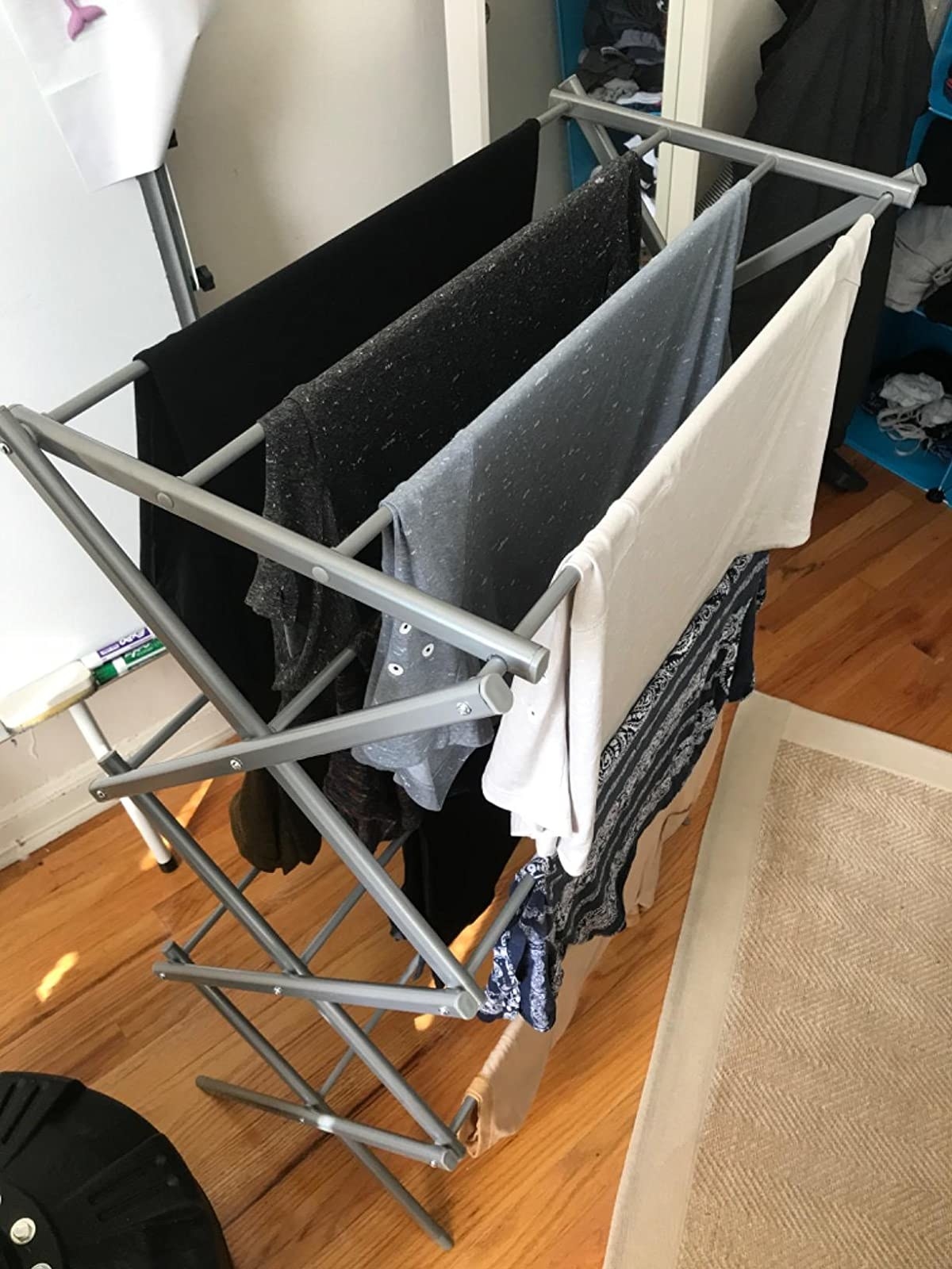 reviewer image of clothes drying on the silver BINO 3-Tier Foldable Drying Rack